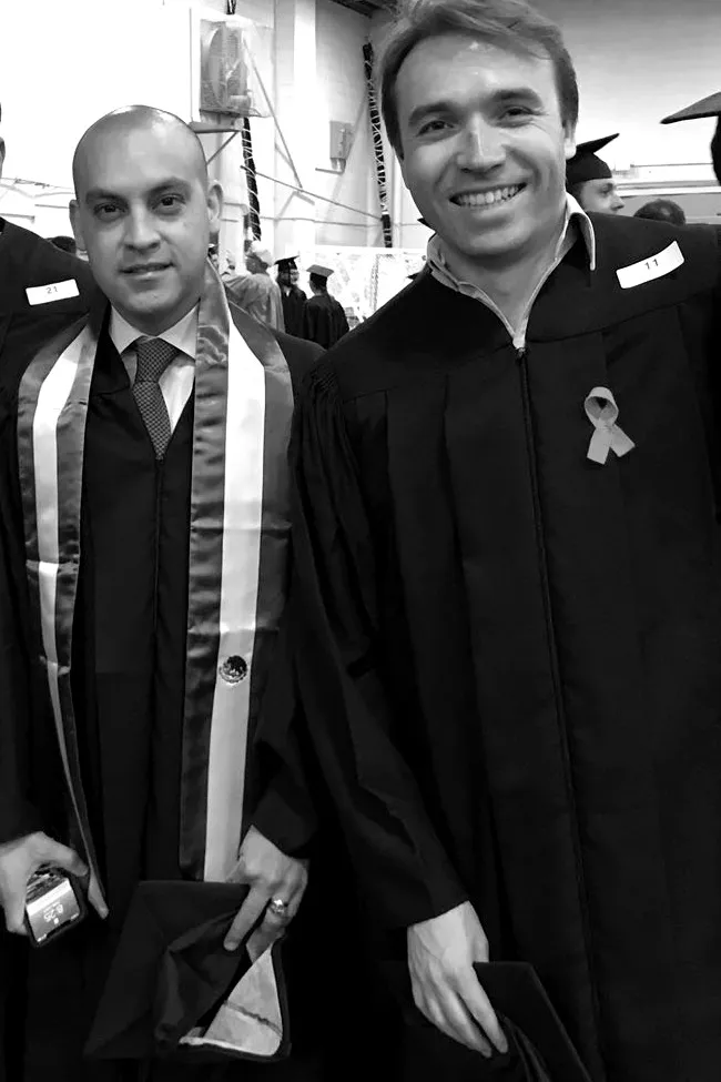 Santiago Guzman and Joseph Peteul in graduation gowns at MIT, 2018.